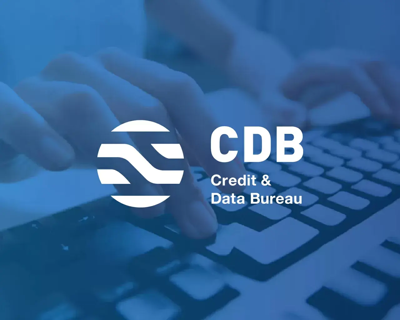 The Credit and Data Bureau logo overlayed over an image of a person typing