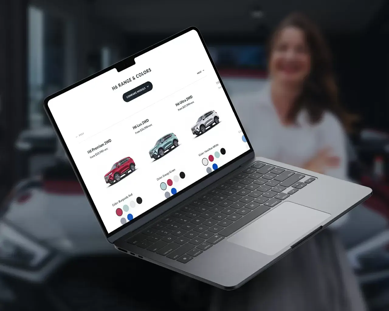 A screenshot of a vehicle model comparison on Cartown's website displayed on a laptop screen.